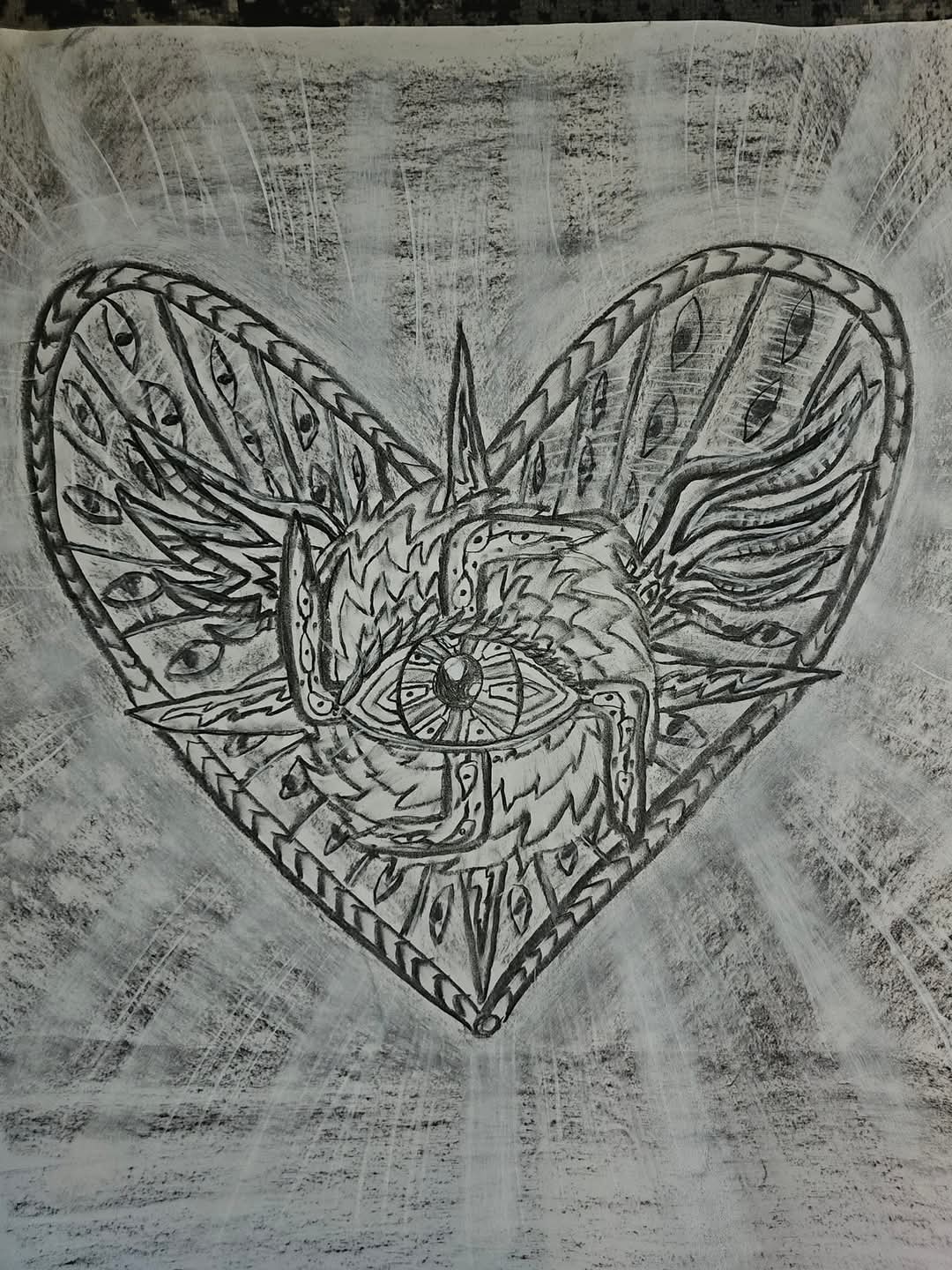 Charcoal drawing on paper of a heart containing a many-eyed, many-winged figure of light whose centre is a large eye, with braided rim and rays of light radiating outward across the paper.